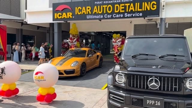 Grand opening of ICAR Ipoh with a lion dance, a yellow Porsche and a G-Class outside the shop