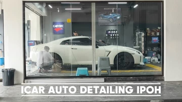 A white Nissan GT-R inside ICAR Ipoh beside the Cartec display